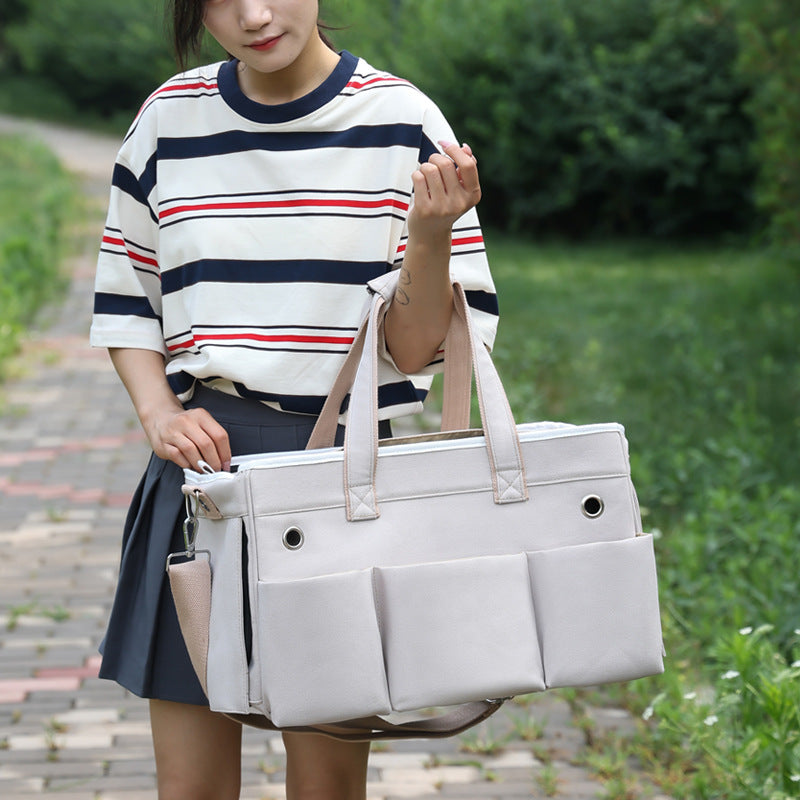 A fashionable and practical pet carrier with multiple pockets and ventilation holes, convenient for pet travel.